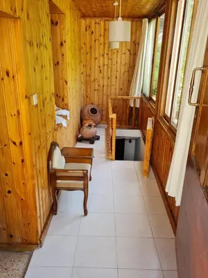 a room with a chair and a teddy bear in it at Elpiniki's Old House in Kalopanayiotis