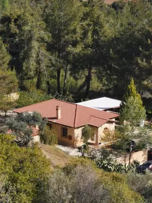 a house with a red roof on a hill at House of Roses in Limassol