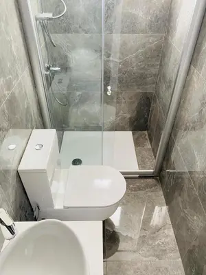a bathroom with a toilet and a glass shower at The Address-Seafront Luxury 2 Bedroom Residence in Limassol