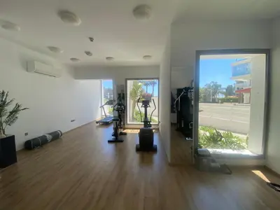an empty room with a gym with a hard wood floor at The Address-Seafront Luxury 2 Bedroom Residence in Limassol