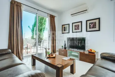 a living room with a television and a table at Villa Seaview in Protaras
