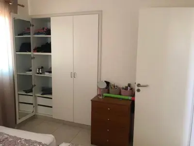 a bedroom with a bed and a dresser and a closet at Paralimni in Paralimni