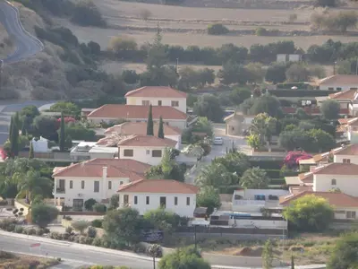 a small town with white houses and a road at Katikies 19 in Pissouri