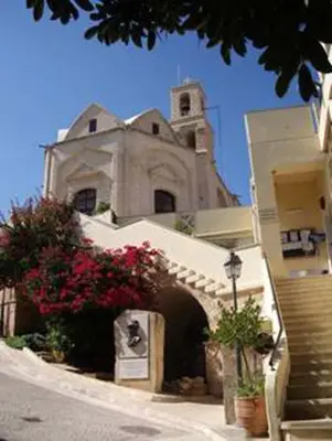 a building with a clock tower on top of it at Katikies 19 in Pissouri
