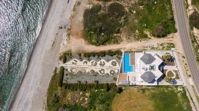 an aerial view of a house next to the ocean at Mediterranean Dream Beachfront Villa in Larnaka