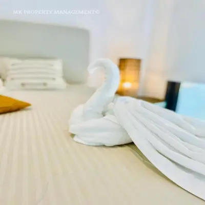 a swan made out of towels on a bed at By the Beach Villa 7 in Protaras