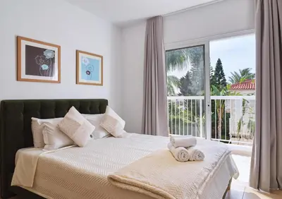 a bedroom with a bed with two towels on it at LuxVillasRentals Ayia Napa in Ayia Napa