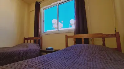 a bedroom with two beds and a window at STAY Chill n' Joy in Ayia Napa