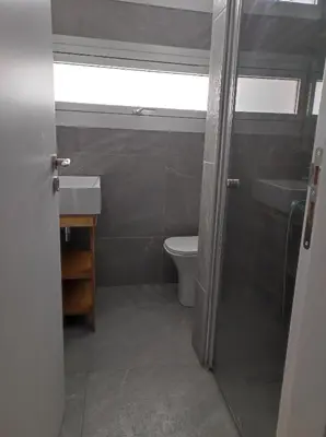 a bathroom with a toilet and a sink and a window at St. Lazaros Studios 2 in Larnaka