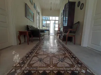 a hallway with a rug on the floor and chairs at St. Lazaros Studios 2 in Larnaka