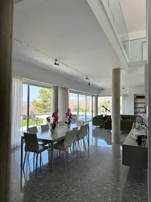 a dining room with a table and chairs at Luxury Villa Pluto Stunning Mountain Views in Ora