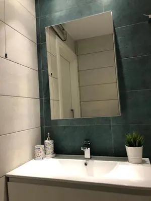 a bathroom with a sink and a mirror at Blue Escape (Beach Seafront) in Larnaka
