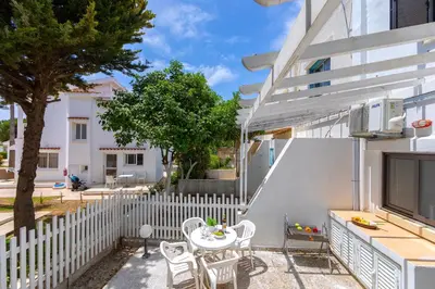 a patio with a white fence and a table and chairs at Maistralli Villa in Protaras