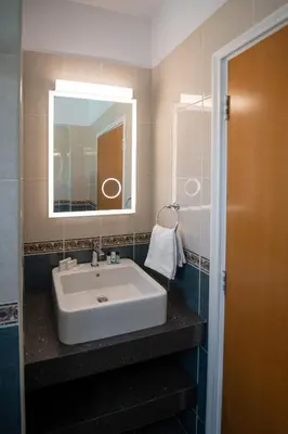 a bathroom with a white sink and a mirror at Luxury Villa Agathoula in Protaras