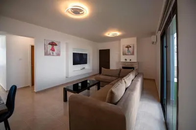 a living room with a couch and a table at Luxury Villa Agathoula in Protaras