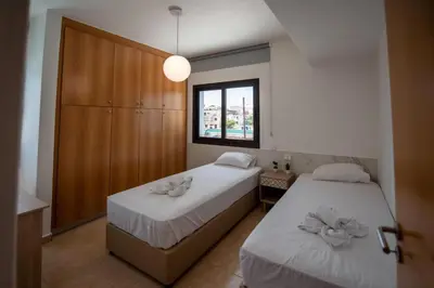 a bedroom with two beds and a window at Luxury Villa Agathoula in Protaras