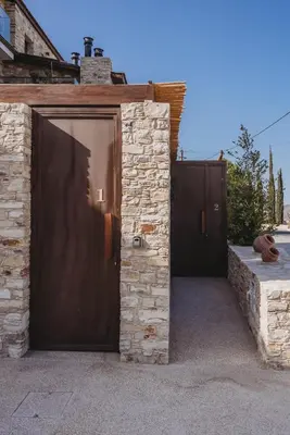two sets of doors on a stone building at Andama Country Living in Pano Lefkara