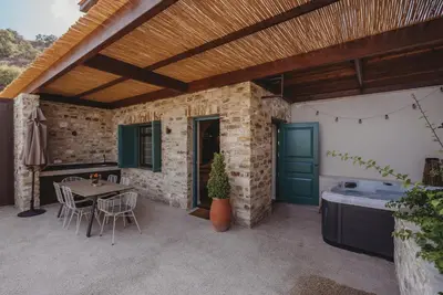 an outdoor patio with a table and a bath tub at Andama Country Living in Pano Lefkara