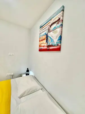 a bedroom with a painting of a bus on the wall at Serene Napa Suites - Heart of Ayia Napa in Ayia Napa
