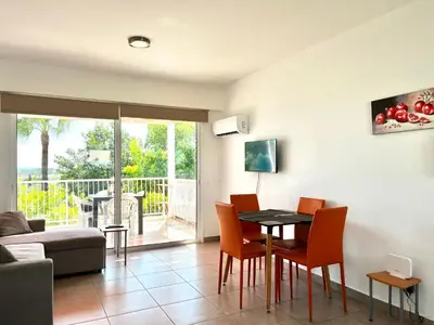 a living room with a table and chairs at STAY Symphony Apartment in Protaras