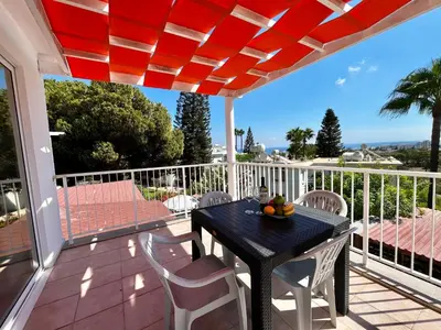 a black table and white chairs on a balcony at STAY Symphony Apartment in Protaras