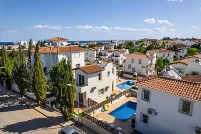 an aerial view of a city with houses and a pool at Villa millie Cyprus in Protaras