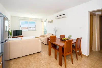 a living room with a table and a couch at SEABREEZE APARTMENT 200m away from the sea in Paralimni