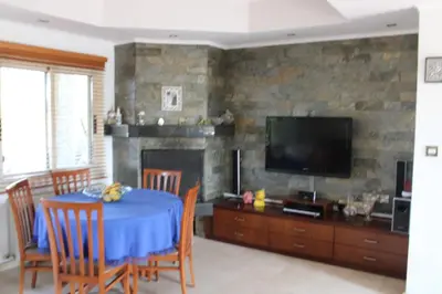 a living room with a table and a tv at Immaculate 3-Bed House in Pentakomo in Pendakomo