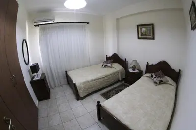 a hotel room with two beds and a window at Eve Pissouri Soultanina Villa in Pissouri