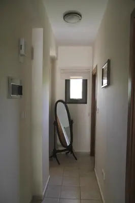 a hallway with a mirror on the wall and a room at Eve Pissouri Soultanina Villa in Pissouri