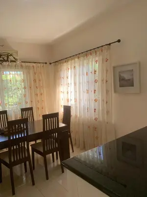 a dining room with a table and chairs at Villa in Protaras in Protaras
