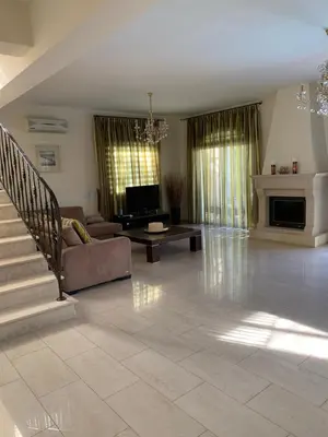 a large living room with a couch and a fireplace at Villa in Protaras in Protaras