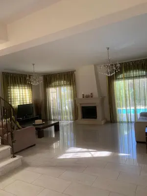 a large living room with a couch and a tv at Villa in Protaras in Protaras