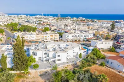 an aerial view of a city with white buildings at Zoi Ayia Napa in Ayia Napa