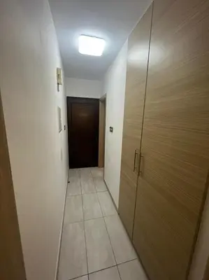 a hallway with a door and a room with a tile floor at Dene Hollow Ayia Napa in Ayia Napa