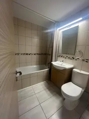 a bathroom with a toilet and a sink and a tub at Dene Hollow Ayia Napa in Ayia Napa