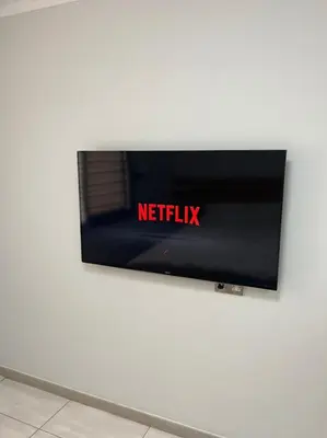 a television on a wall with the netflix sign on it at Dene Hollow Ayia Napa in Ayia Napa