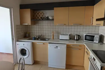 a kitchen with a washing machine and a washer at Carisa DownTown with Rooftop pool in Larnaka