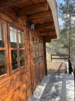 a wooden cabin with a large wooden door at Bosco Paradiso in Limassol