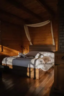 a bed in a wooden room with a teddy bear on it at Bosco Paradiso in Limassol