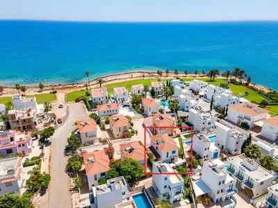 an aerial view of a village next to the ocean at Villa Serena Springs by Ezoria Villas in Protaras