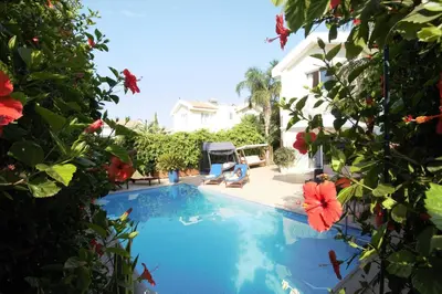 a swimming pool in the backyard of a house at Helene Villa in Protaras