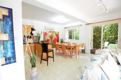 a living room with a table and a dining room at Helene Villa in Protaras