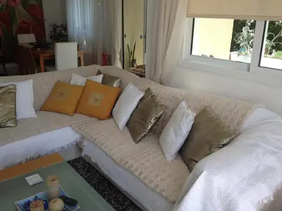 a white couch with many pillows on it at Helene Villa in Protaras