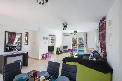 a living room with a couch and a table at Antonia Villa in Protaras