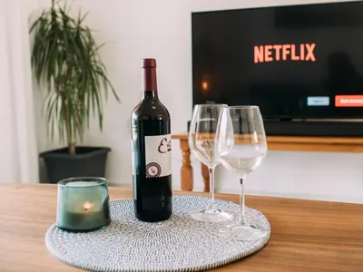 a bottle of wine and two glasses on a table at The Salnik Beach Apartment in Limassol