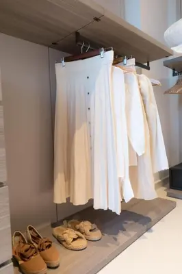 a closet with a rack of white clothes and shoes at Love Bridge Seaview Villas in Ayia Napa