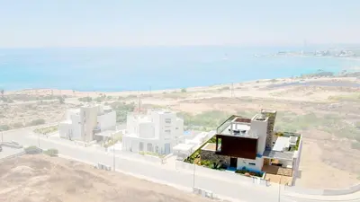 a rendering of a building on a hill next to the ocean at Love Bridge Seaview Villas in Ayia Napa