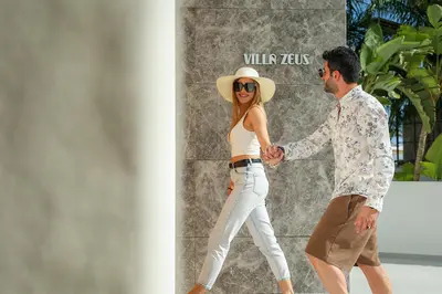 a man and a woman holding hands while walking at Mythical Villas Zeus and Venus in Protaras