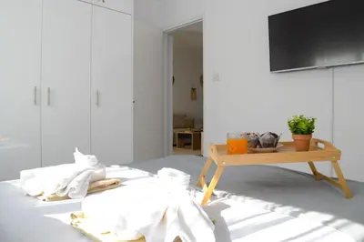 a living room with a television and a table at Coastal Getaway in Larnaka